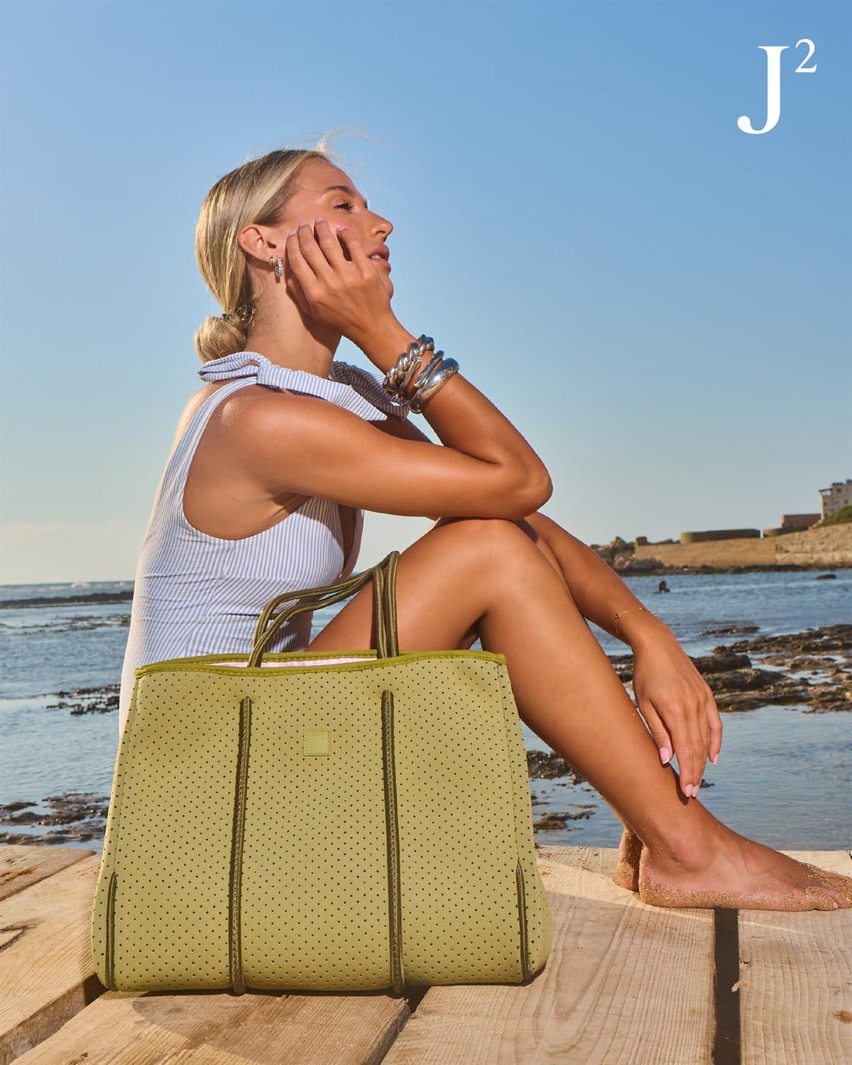 The tote in Sage on the boardwalk, under the J² monogram